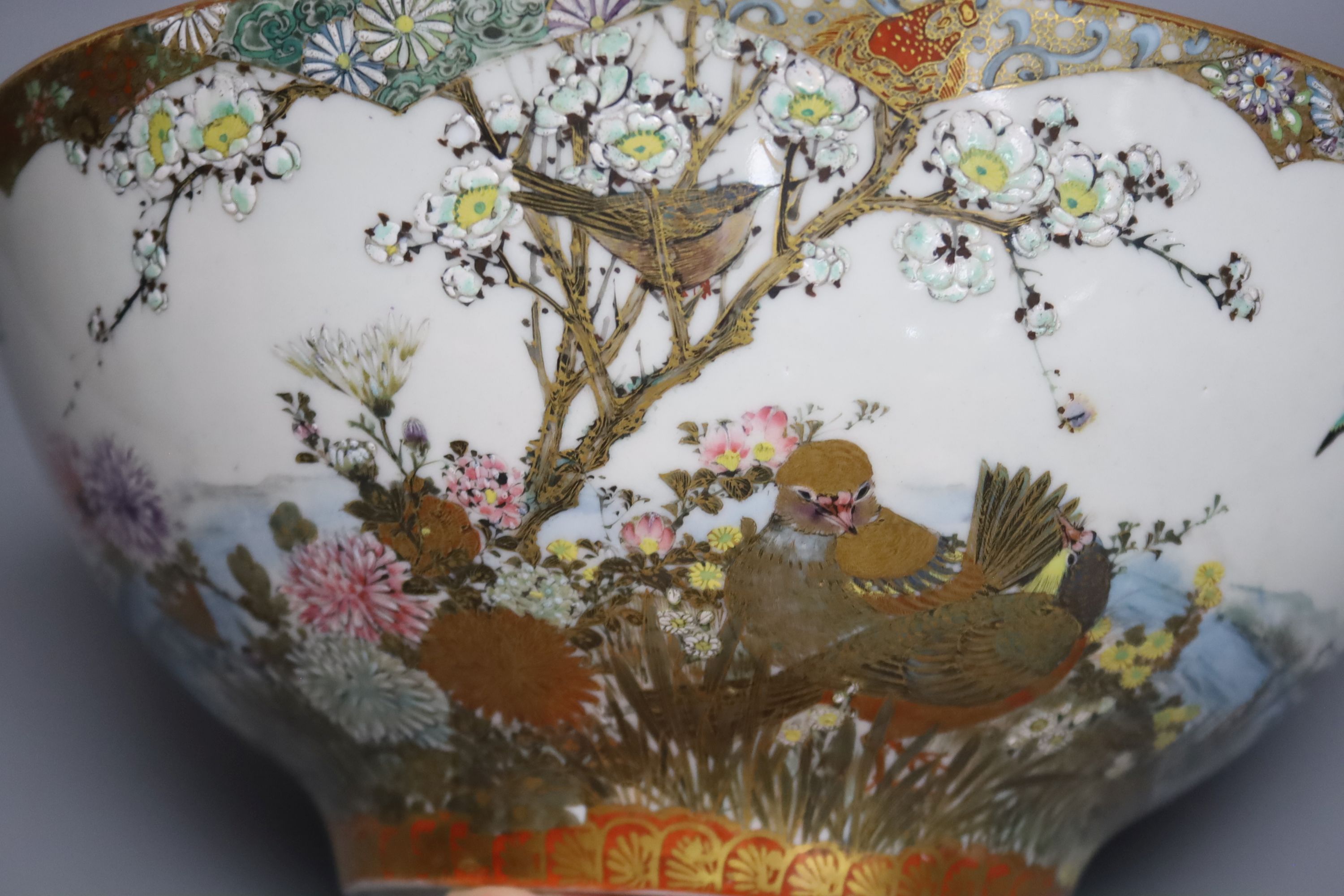 A large early 20th century Japanese Kutani bowl, painted with peacocks and flowers, 13cm high, 31cm diam